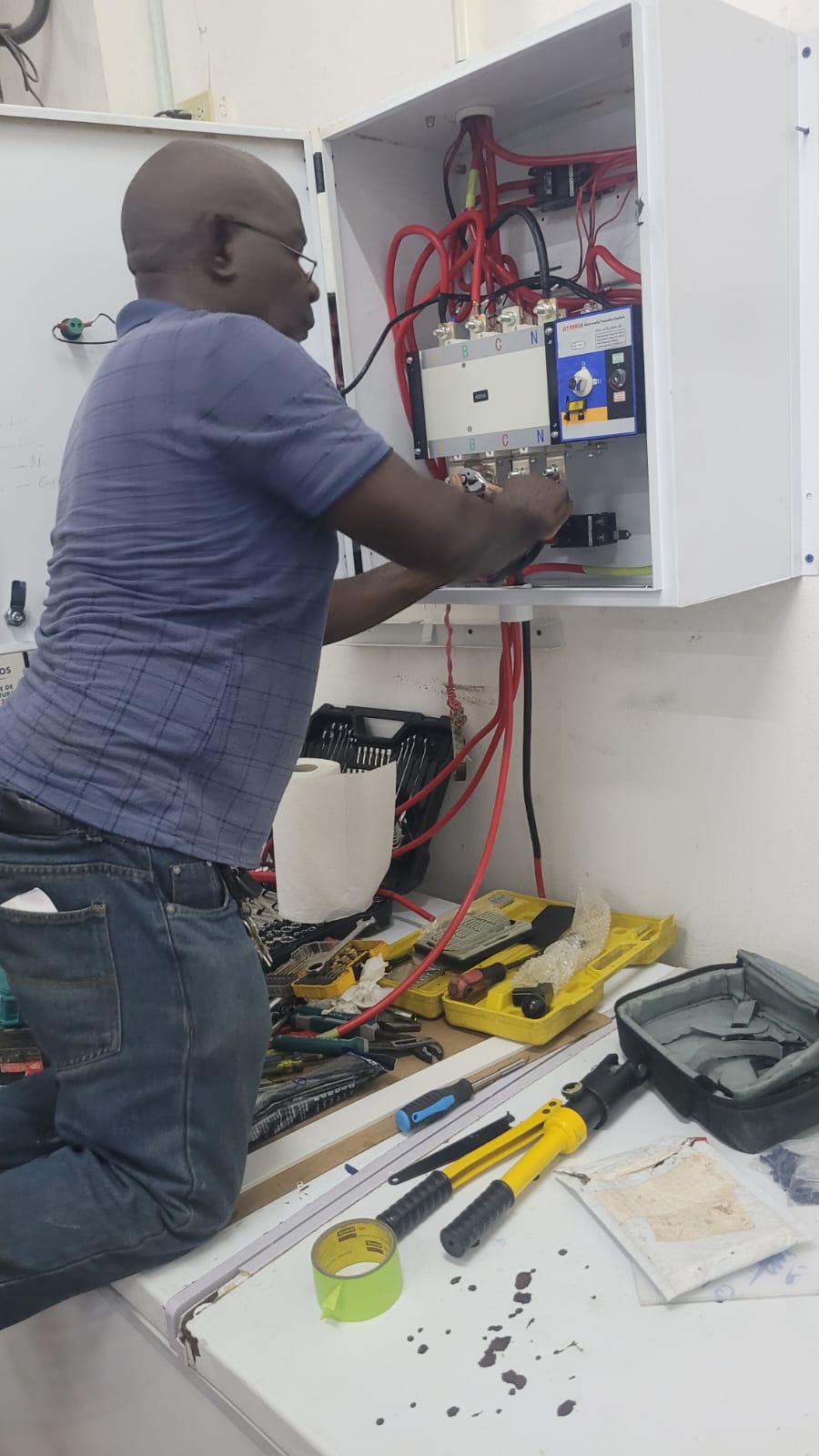 Technician working on ATS panel