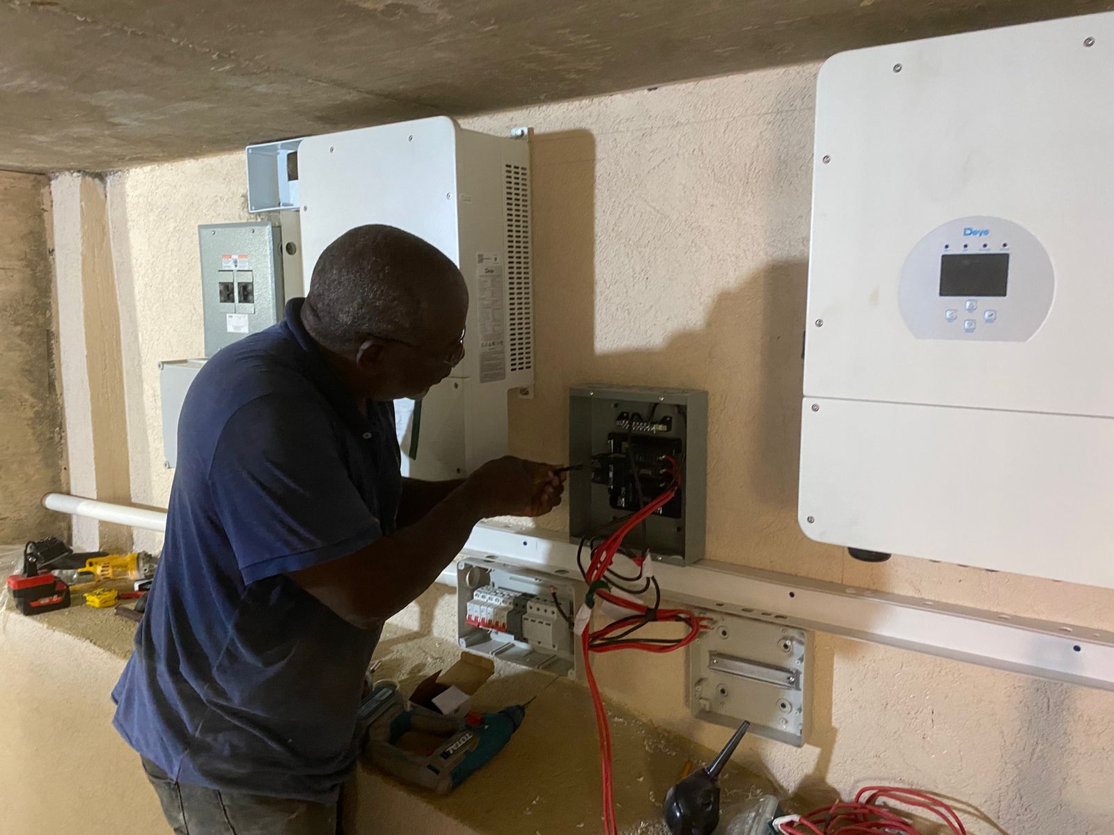 Technician working on paired inverters